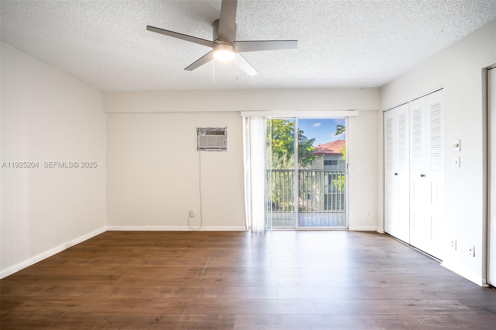 100 Southwest 132nd Way, Unit 306K Pembroke Pines, FL 33027 - Photo 11 of 31 an empty room with wooden floor and windows