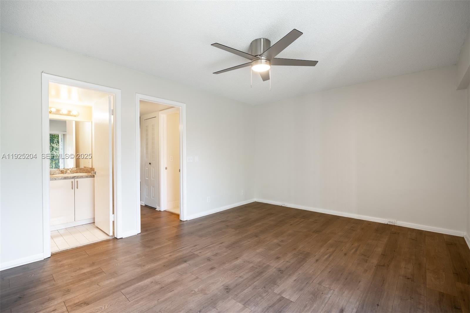 100 Southwest 132nd Way, Unit 306K Pembroke Pines, FL 33027 - Photo 12 of 31 an empty room with wooden floor door and windows