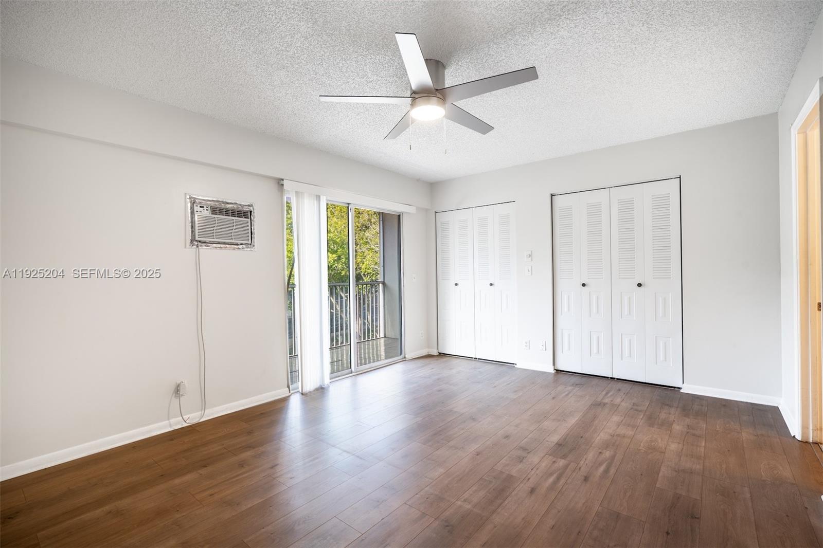 100 Southwest 132nd Way, Unit 306K Pembroke Pines, FL 33027 - Photo 13 of 31 a view of an empty room with wooden floor