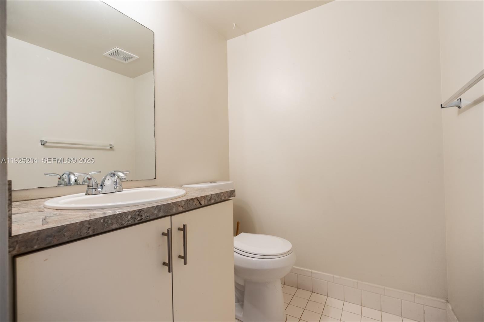 100 Southwest 132nd Way, Unit 306K Pembroke Pines, FL 33027 - Photo 15 of 31 a bathroom with a granite countertop sink a toilet and a mirror