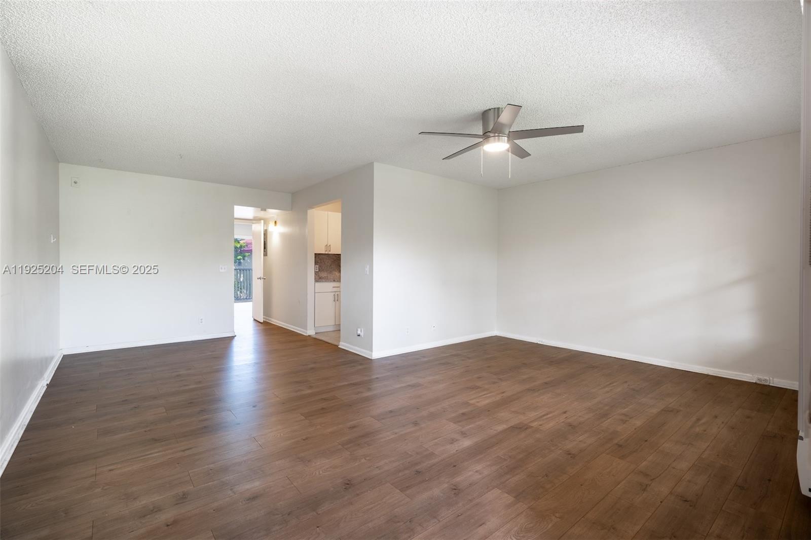 100 Southwest 132nd Way, Unit 306K Pembroke Pines, FL 33027 - Photo 2 of 31 wooden floor in an empty room with a window