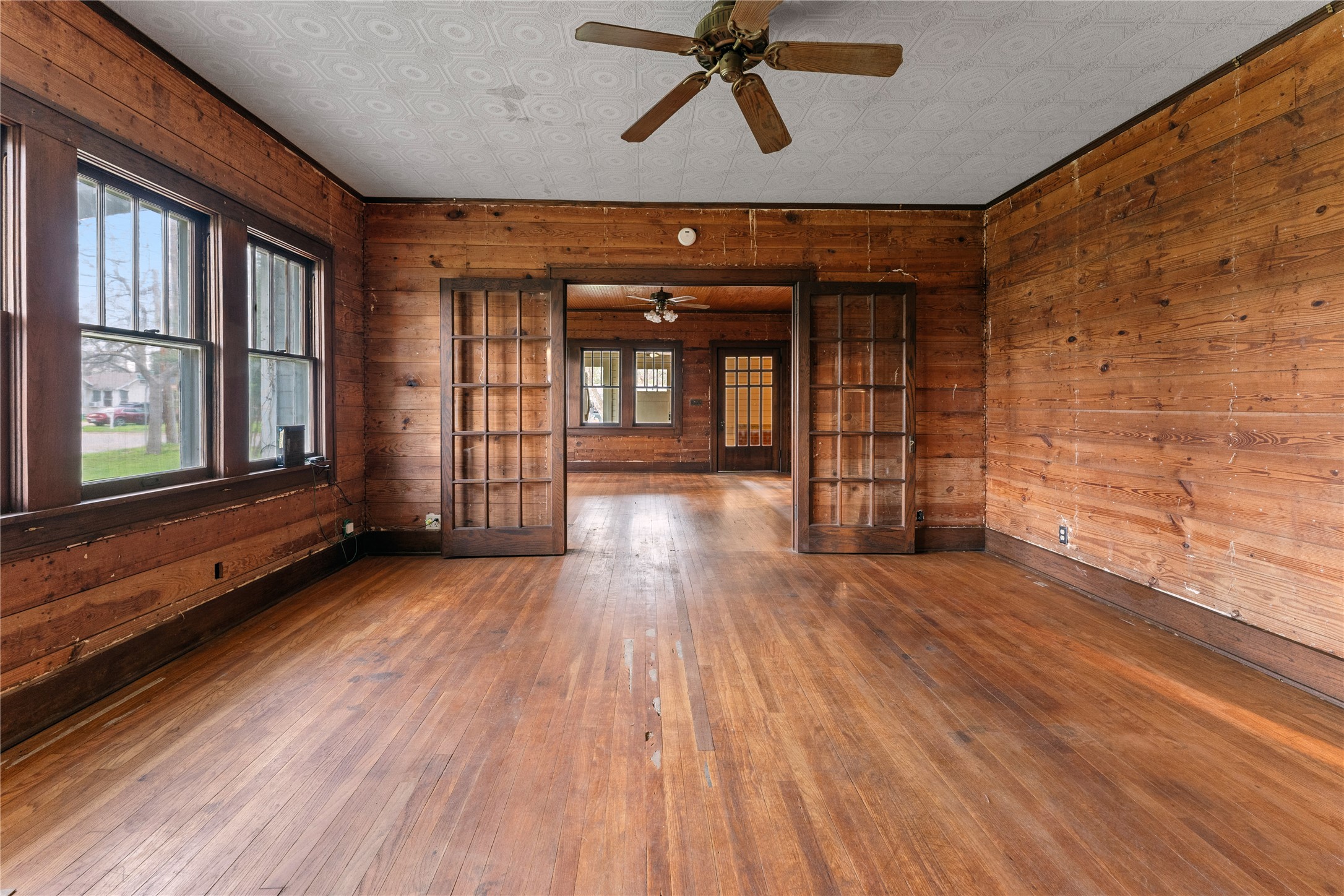 501 East 6th Street Cameron, TX 76520 - Photo 24 of 39 Spare room with hardwood / wood-style flooring and wood walls