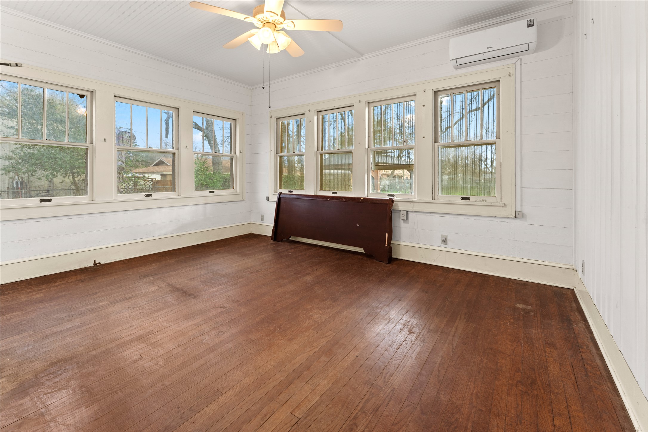 501 East 6th Street Cameron, TX 76520 - Photo 31 of 39 Unfurnished sunroom with an AC wall unit and a ceiling fan