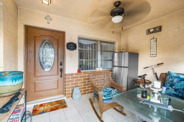 a living room with furniture a rug and a clock