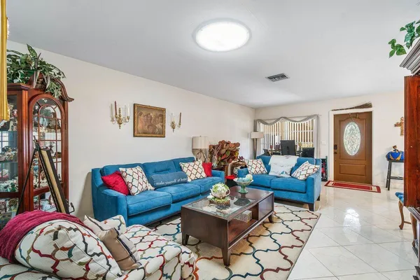 a living room with furniture a rug and a flat screen tv