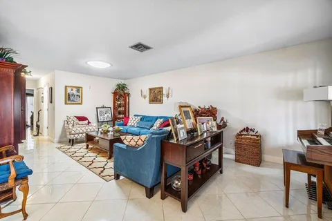a living room with furniture and a baby crib