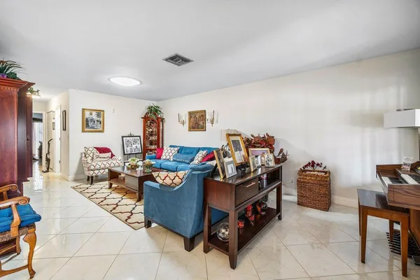 a living room with furniture and a baby crib