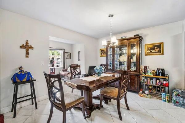 a view of a dining room with furniture and a chandelier
