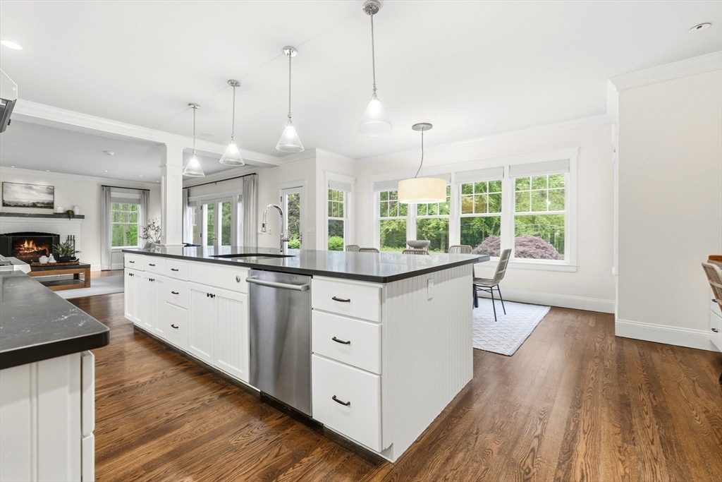244 Musterfield Road Concord, MA 01742 - Photo 9 of 42 a kitchen with stainless steel appliances granite countertop a stove a sink a center island and a wooden floor
