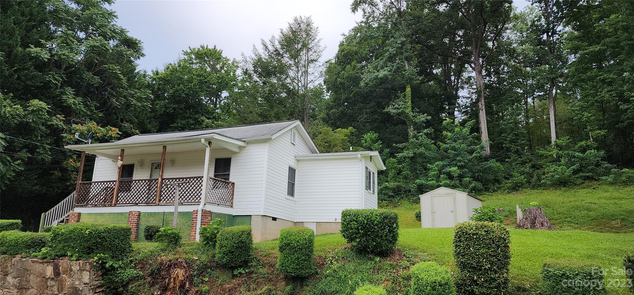 19 Rector Street Tryon, NC 28782 - Photo 1 of 26 a view of a white house with a small yard and large trees