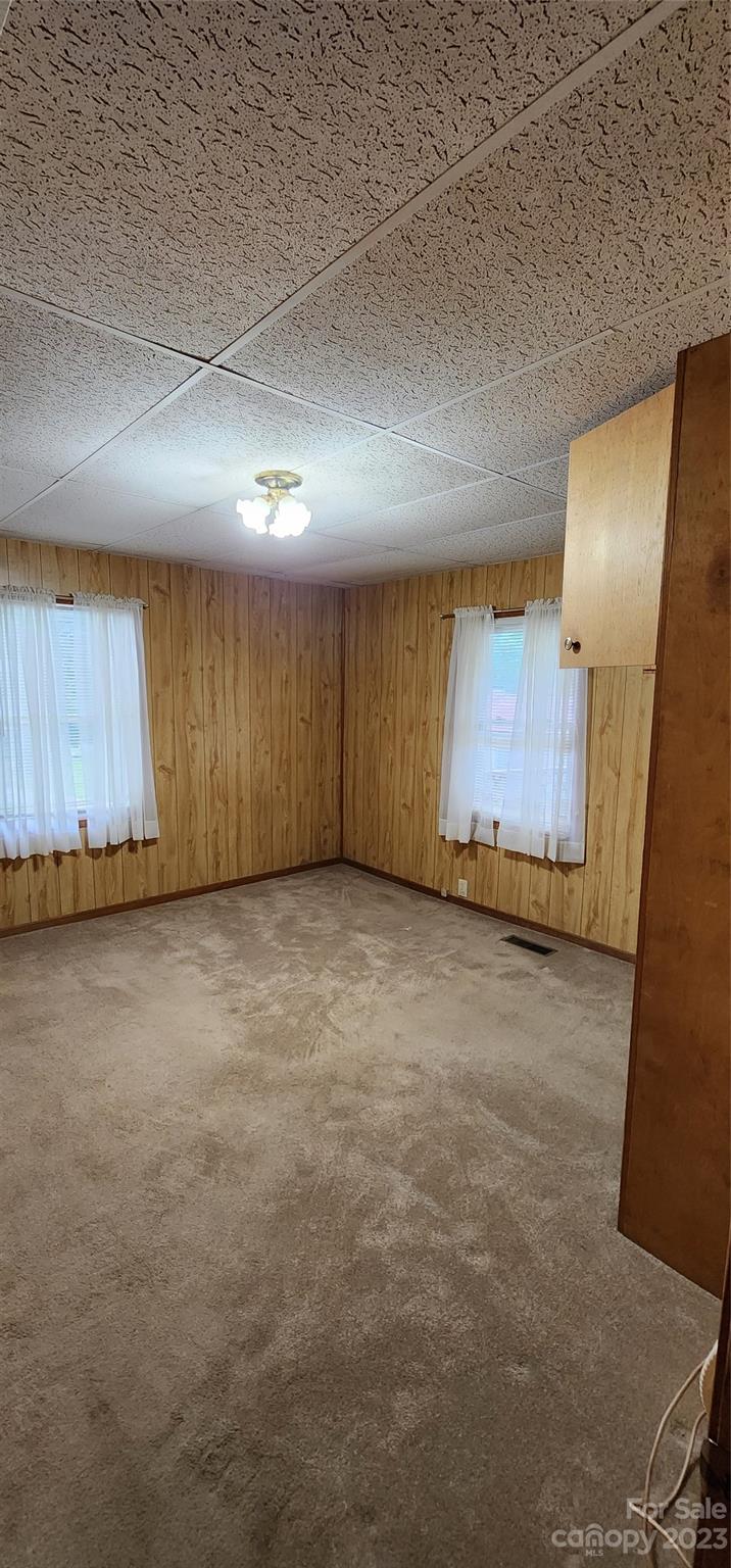 19 Rector Street Tryon, NC 28782 - Photo 15 of 26 an empty room with wooden floor and windows