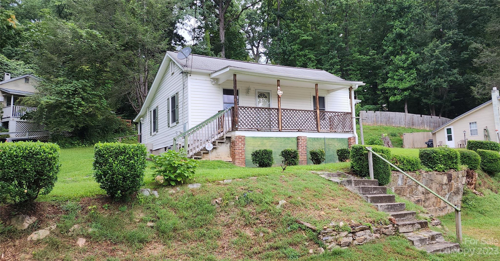 19 Rector Street Tryon, NC 28782 - Photo 4 of 26 a view of a house with a yard and plants
