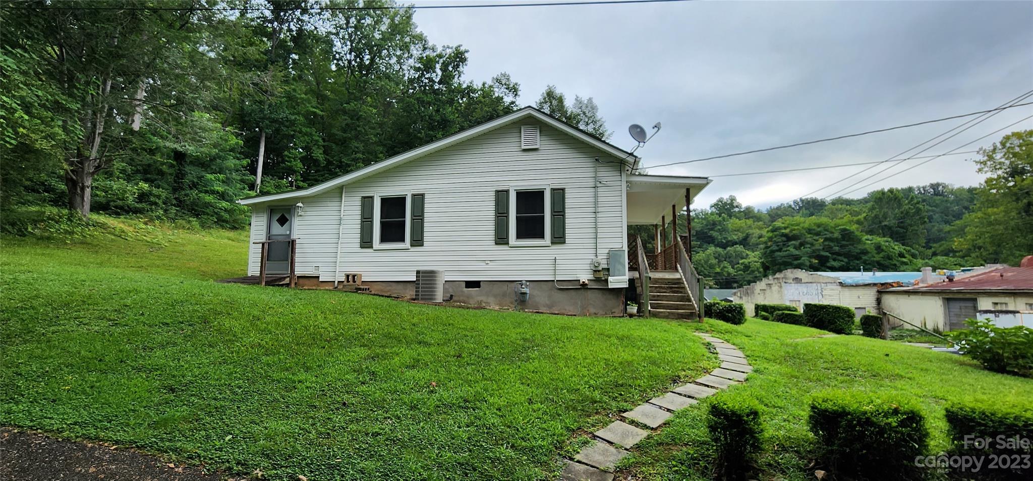 19 Rector Street Tryon, NC 28782 - Photo 9 of 26 a view of a house with a yard and garden