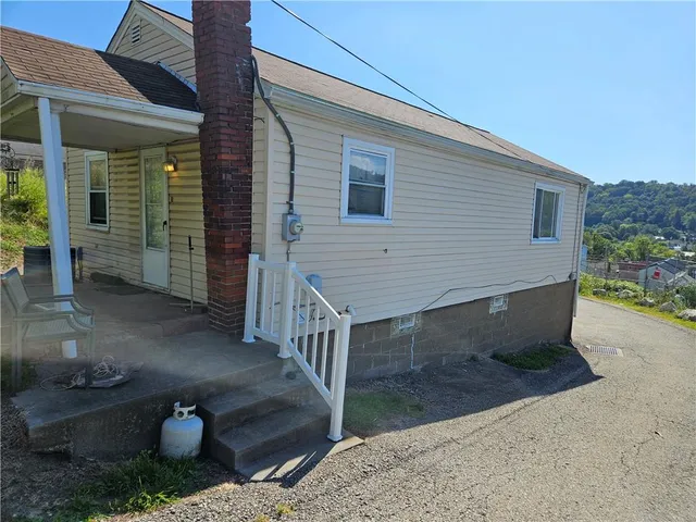 a view of a patio with table and chairs with wooden fence and plants
