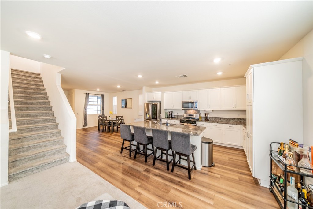 1810 Parkplace Lane Riverside, CA 92501 - Photo 12 of 52 a view of a dining room with furniture and wooden floor
