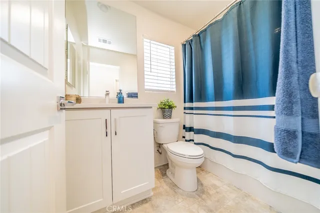 a bathroom with a sink toilet and window