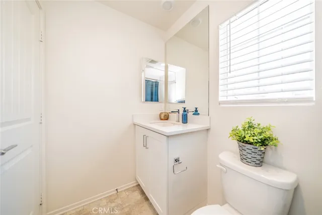 a bathroom with a sink toilet and mirror