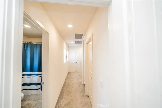 a view of a hallway with a white walls