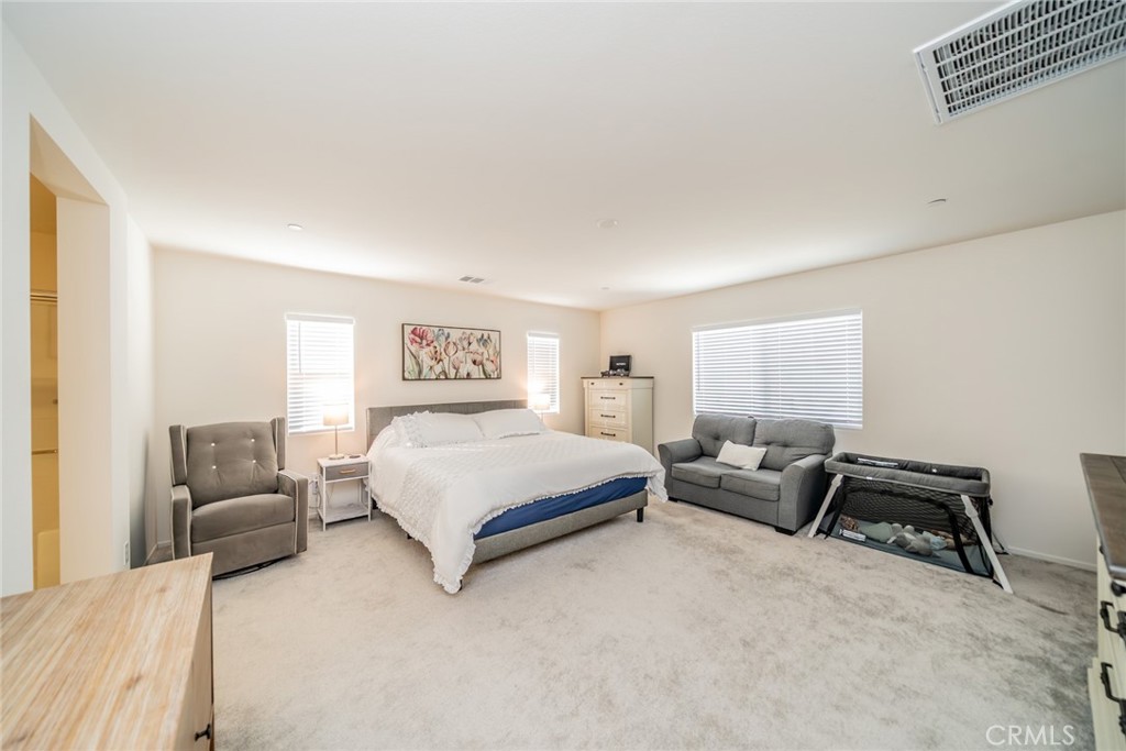 1810 Parkplace Lane Riverside, CA 92501 - Photo 25 of 52 a spacious bedroom with a bed couch and a window