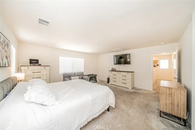 a bedroom with a large bed and a tv