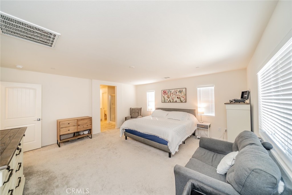 1810 Parkplace Lane Riverside, CA 92501 - Photo 27 of 52 a bedroom with a bed and a couch