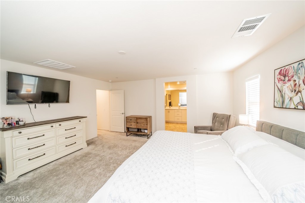 1810 Parkplace Lane Riverside, CA 92501 - Photo 28 of 52 a bedroom with a bed and a flat screen tv