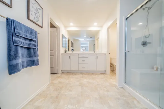 a view of a kitchen cabinets and a refrigerator