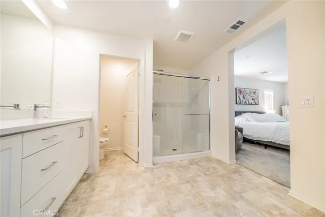 a spacious bathroom with a double vanity sink and mirror