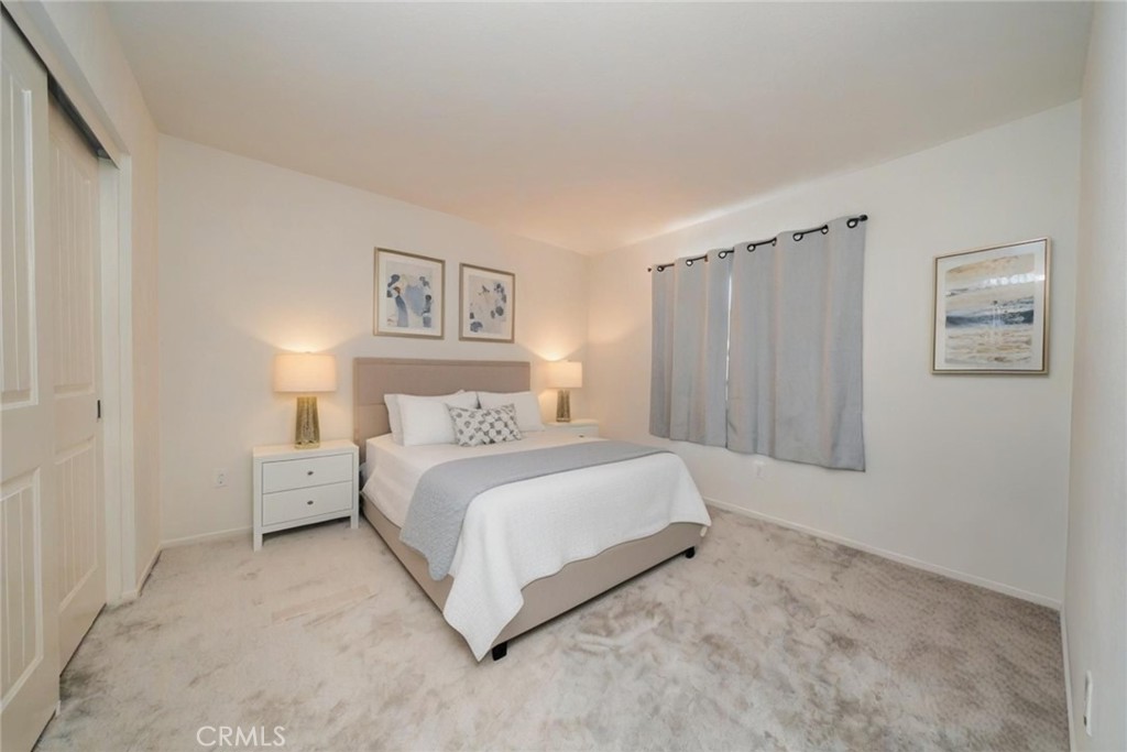 1810 Parkplace Lane Riverside, CA 92501 - Photo 32 of 52 a spacious bedroom with a bed and a walk in closet