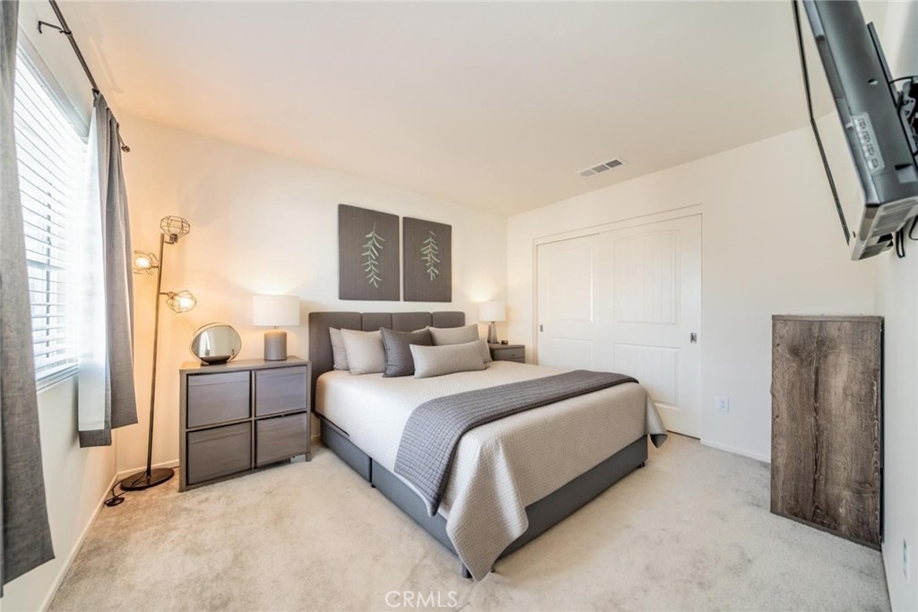 1810 Parkplace Lane Riverside, CA 92501 - Photo 33 of 52 a bedroom with a bed and a painting on the wall