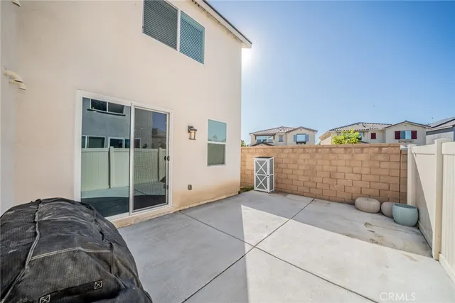 a view of a bedroom with a bed and ceiling fan