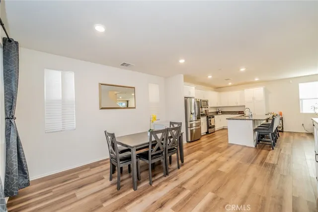 a view of a dining room with furniture and wooden floor