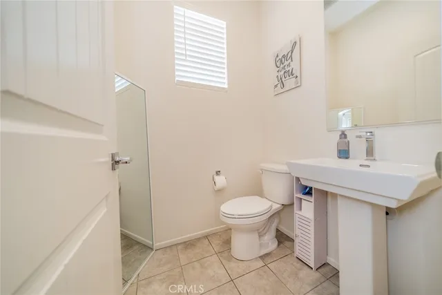 a bathroom with a sink toilet and a mirror