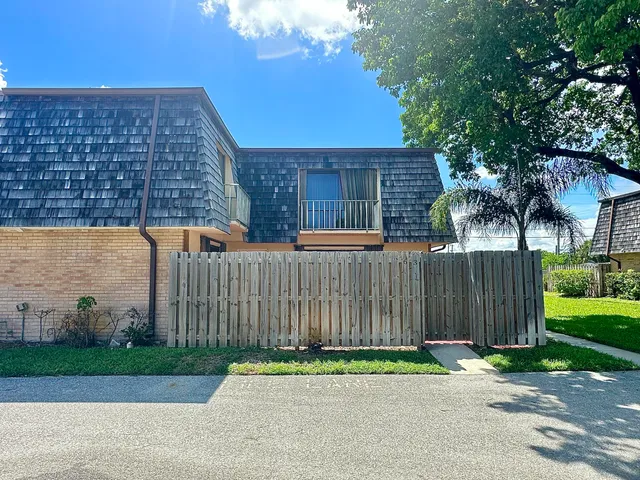 a backyard of a house with a garden and deck