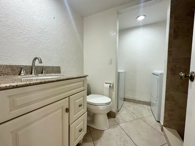 a bathroom with a toilet sink and shower