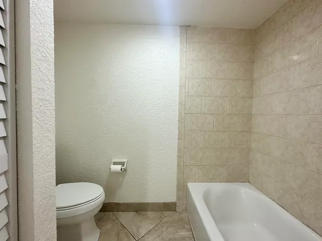 a view of a livingroom with a ceiling fan and window
