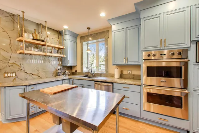 a dining hall with stainless steel appliances granite countertop lots of counter top space and furniture