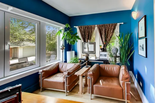a spacious bedroom with a bed and a chandelier