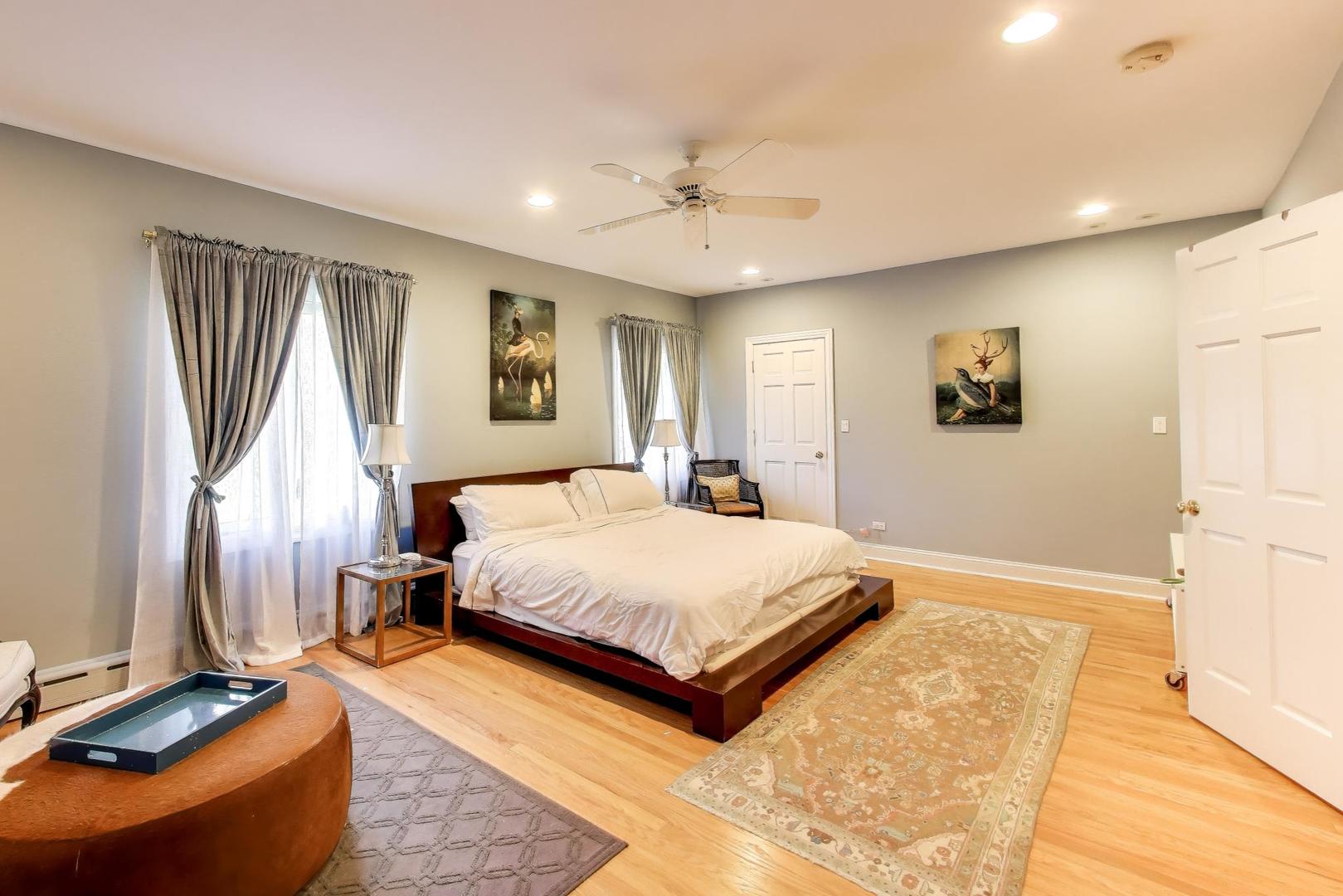 823 Jackson Avenue River Forest, IL 60305 - Photo 23 of 60 a spacious bedroom with a bed and a chandelier