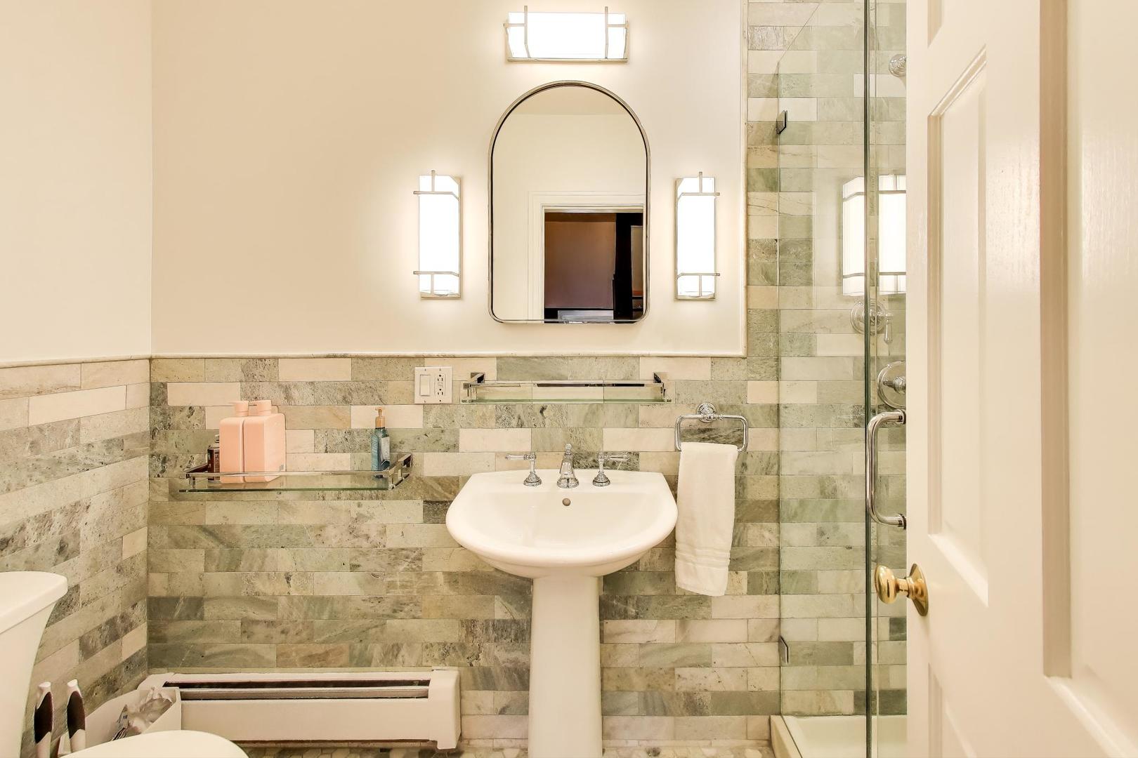 823 Jackson Avenue River Forest, IL 60305 - Photo 32 of 60 a bathroom with a sink a mirror and a shower