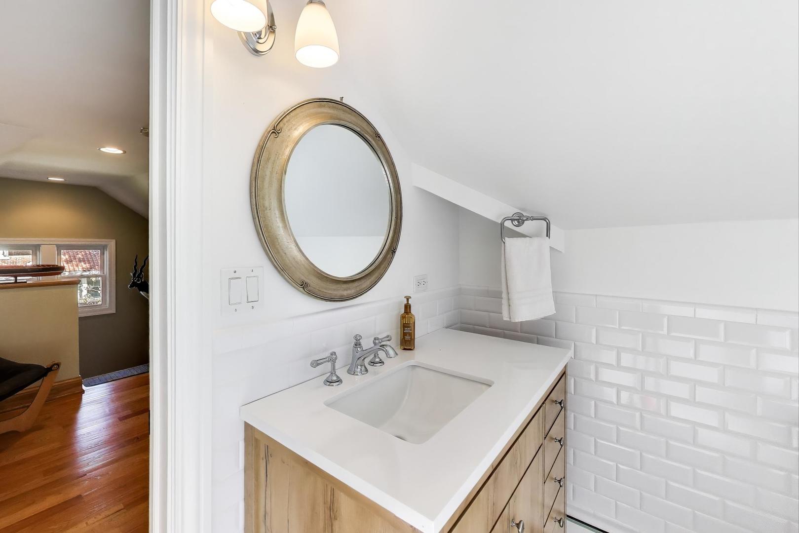 823 Jackson Avenue River Forest, IL 60305 - Photo 38 of 60 a bathroom with a sink a vanity and a mirror