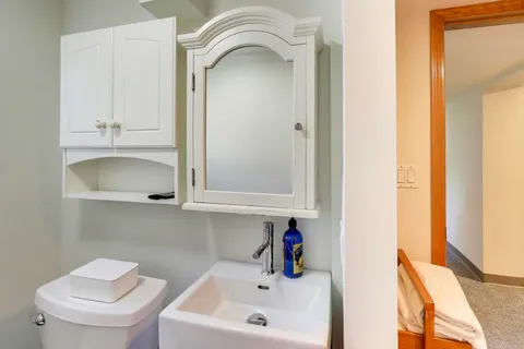 a front view of a house with a garden and sitting area