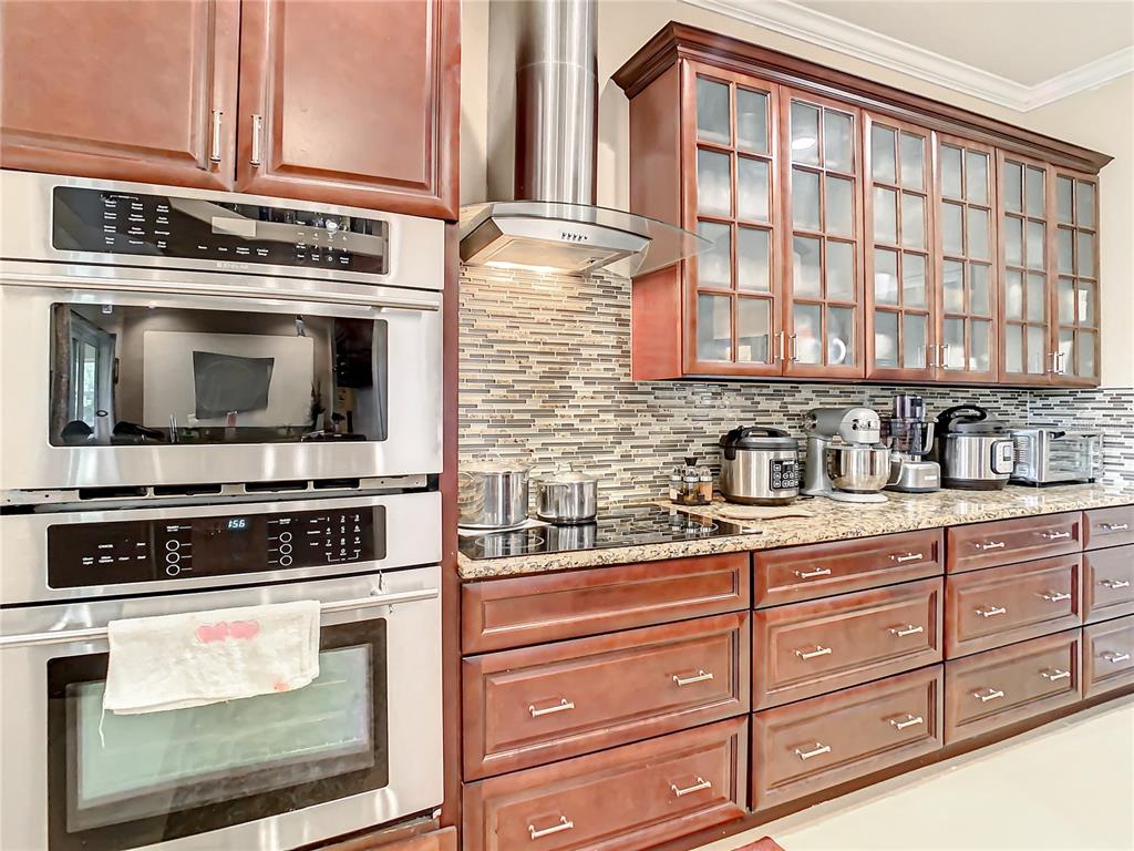 16300 Johns Lake Road Clermont, FL 34711 - Photo 29 of 76 a kitchen with stainless steel appliances granite countertop a stove and a microwave