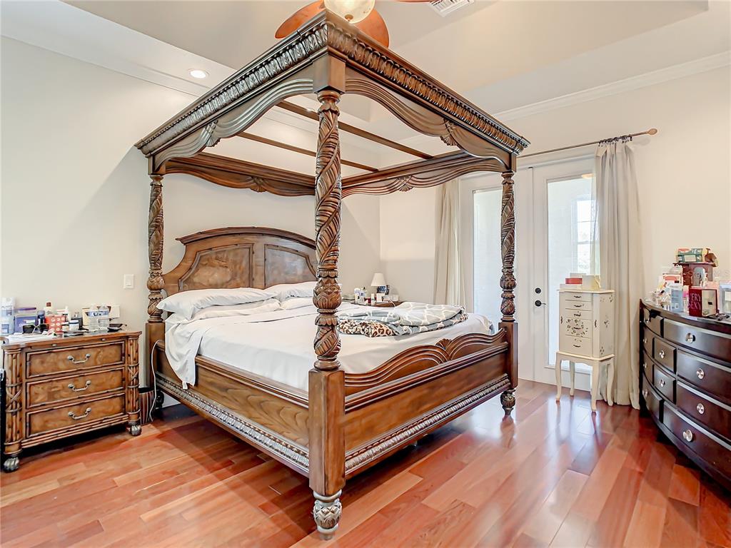 16300 Johns Lake Road Clermont, FL 34711 - Photo 32 of 76 a bedroom with a bed and wooden floor