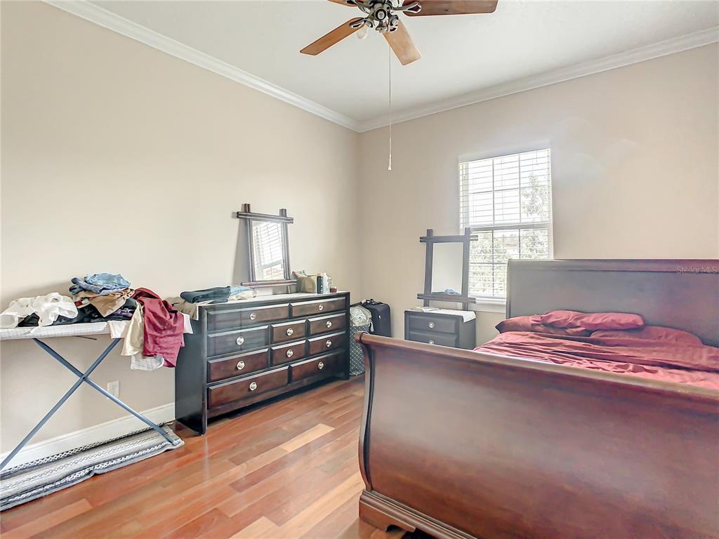 16300 Johns Lake Road Clermont, FL 34711 - Photo 42 of 76 a bedroom with a bed and a dresser