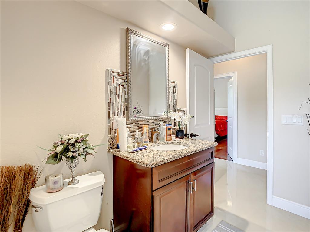16300 Johns Lake Road Clermont, FL 34711 - Photo 45 of 76 a bathroom with a sink and a mirror
