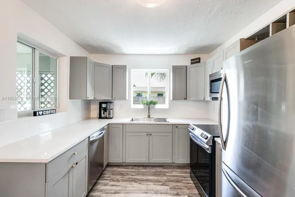 a kitchen with a sink stove and refrigerator