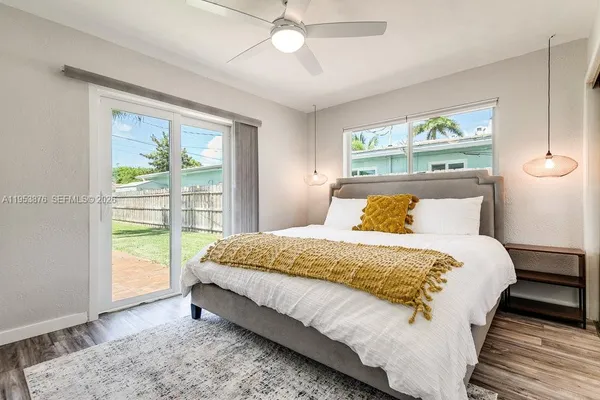 a bed sitting in a bedroom next to a window