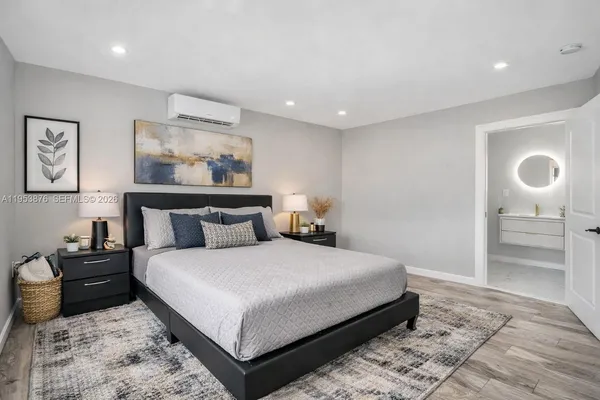 a bedroom with a bed and painting on the wall