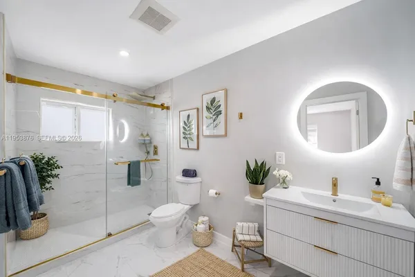 a bathroom with a toilet sink and shower